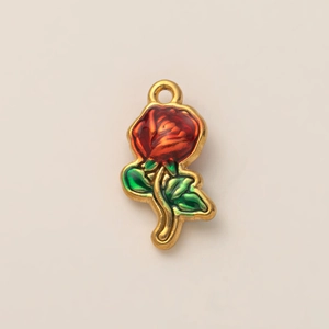 Dettaglio di un ciondolo a forma di rosa placcato oro 18K con smalto rosso e verde