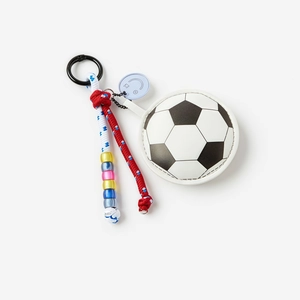 Detail view of football keychain featuring leather texture, braided ropes and colorful beads