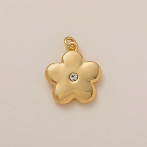 Detailed macro view of gold flower pendant featuring a central sparkling zircon stone