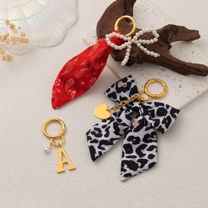 Fashionable leopard print bow and pearl bow keychains with vintage metal charms