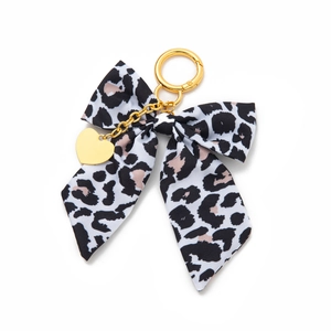Leopard print bow bag charm with gold keychain ring and heart pendant detail