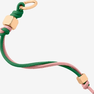Close-up of green and pink woven leather keychain with gold hexagonal metal beads