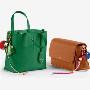 Green leather tote and brown crossbody bag with colorful strawberry fashion charms