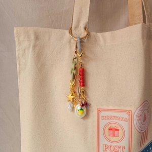 Colorful mix of acrylic links, pearl, and fruit enamel charm on gold keychain pendant