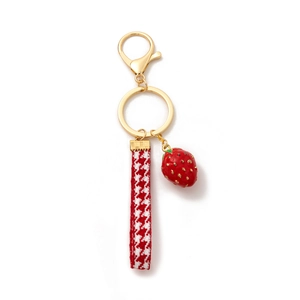 Fashionable strawberry keychain with gold clasp and red houndstooth ribbon for bags