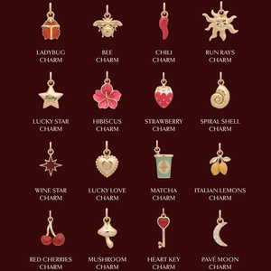 Vue détaillée de breloques plaquées or 18 carats avec motifs émaillés fruits et insectes