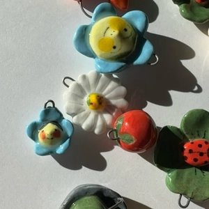 Colorful ceramic pendants featuring blue flowers, red apples and green leaves with metal rings