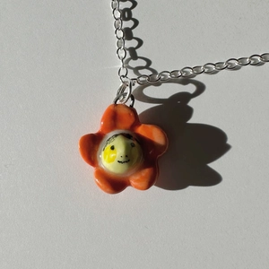 Colorful dopamine orange flower pendant necklace in stainless steel with a smiley face