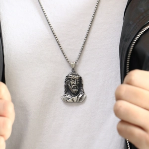 Silver Jesus pendant necklace for men with box chain, styled with a black leather jacket