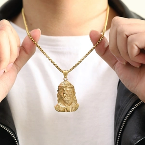 Detail of gold Jesus portrait pendant featuring intricate textures and square box chain