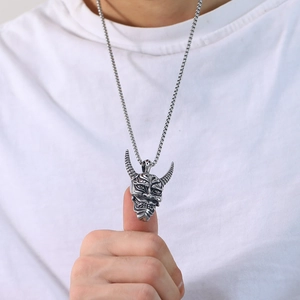 Macro shot of punk style stainless steel demon pendant with intricate textures