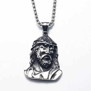 Macro detail of silver Jesus Christ portrait pendant with retro punk engraving style