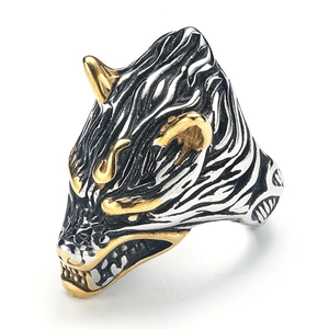 Macro detail of Viking wolf head ring featuring silver and gold electroplated finish