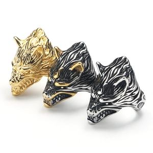 Macro detail of viking wolf head ring showing intricate metal textures and patterns
