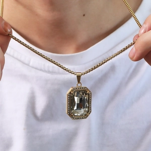 Detail of a large rectangular crystal pendant with pavé cubic zirconia on a gold box chain