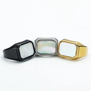 Detailed view of square shell inlays on black, silver, and gold titanium steel rings