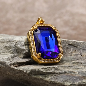 Detailed close-up of square blue sapphire pendant with gold-plated micro-pave zircon setting