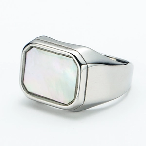 Macro view showing the rectangular white shell inlay on a brushed silver titanium ring