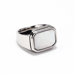 Detail of square white shell inlay on a polished silver titanium steel ring