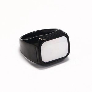 Detailed view of the square white shell inlay on a black titanium steel ring band
