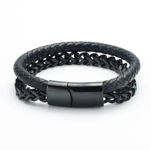 Detail of men's double-layer black braided leather and wheat chain bracelet with magnetic clasp