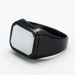 Detail view of the black titanium signet ring with a rectangular white shell inlay