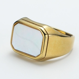 Macro shot of gold-plated signet ring featuring a rectangular white shell inlay design