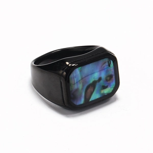 Polished black titanium steel ring featuring a rectangular rainbow abalone shell inlay