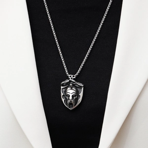 Detailed relief of skull and serpent on a shield pendant necklace for men in silver steel
