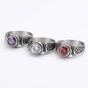 Detail of vintage rings with purple, white and red gemstones and filigree patterns