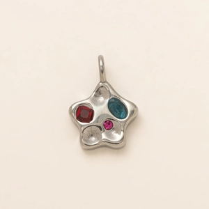 Star shaped 18K gold pendant with ruby sapphire and pink stones in a fluid silver design