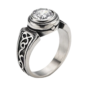 Macro shot of retro men's titanium steel ring with white gemstone and Celtic engraving