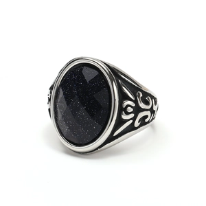 Dettaglio macro dell'anello punk vintage con pietra blu e motivi metallici in rilievo