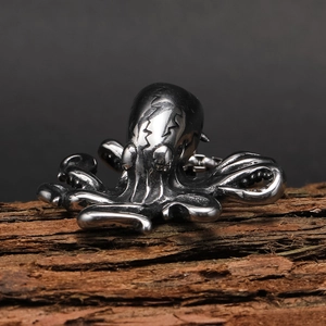 Macro view of detailed octopus pendant tentacles on a rustic tree bark background