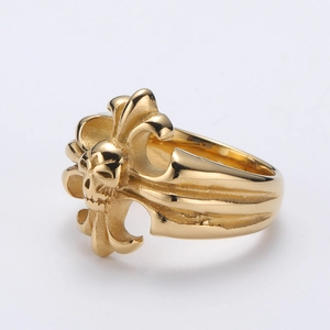 Macro shot of gold stainless steel skull and gothic cross ring with vintage texture