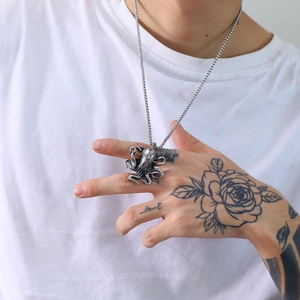 Detailed close-up of a vintage silver octopus pendant on a simple metal chain