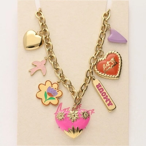 Detail of chunky gold chain necklace with colorful enamel heart and flower charms