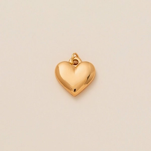 Polished gold heart pendant with shiny metallic finish and classic minimalist design