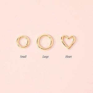Detailed view of small, large, and heart-shaped gold-plated jewelry connectors