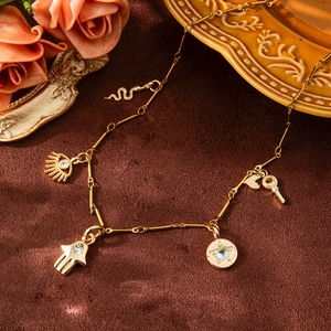 Vintage gold multi-pendant necklace featuring Hamsa Hand, Evil Eye, and star charms