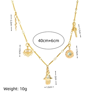 Fashionable gold charm necklace featuring snake, evil eye, and key pendants with size specs