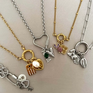 Elegant gold and silver charm necklaces with pearl, heart, and gemstone pendants