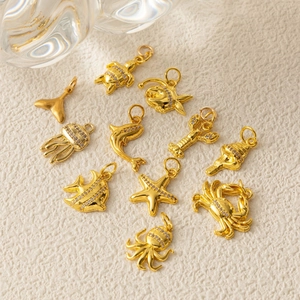 Golden sea life pendant set with zircon inlay featuring turtles, starfish and sea shells