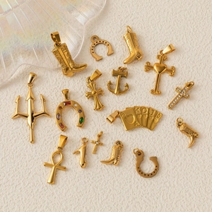 Assortment of gold plated stainless steel charms including cross, horseshoe and poker designs