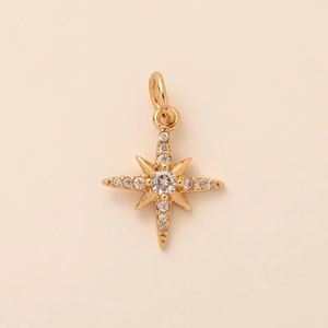 Detailed macro view of an 18K gold plated North Star pendant with crystal embellishments