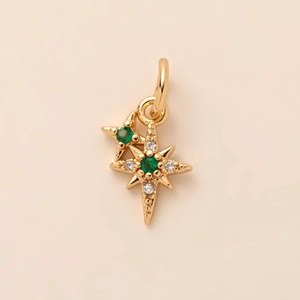 Golden sunburst star pendant necklace with green crystal inlay and white diamond accents