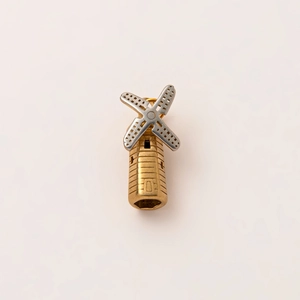 Macro detail of a vintage 18K gold windmill pendant with silver textured blades
