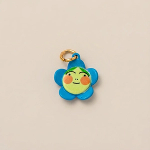 Detailed view of a blue flower pendant charm with a cute face and golden ring