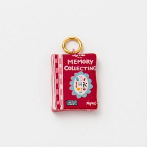 Detailed view of dark red memory collecting pendant with gold ring and plaid pattern