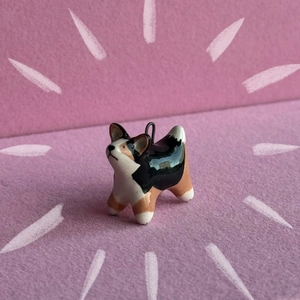 Detailed view of hand-painted ceramic Corgi charm with glossy finish and metal ring